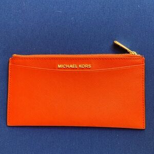 Very cute leather Michael Kors Wallet. Used in good condition. Very slim